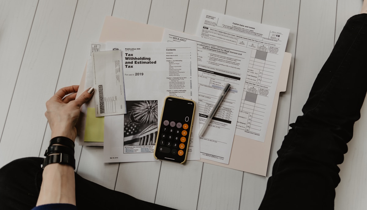 Hands reviewing a contract on a kitchen table